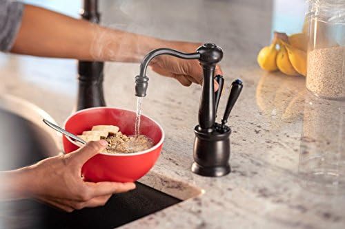 Person dispensing hot water into a bowl of oatmeal from the InSinkErator faucet