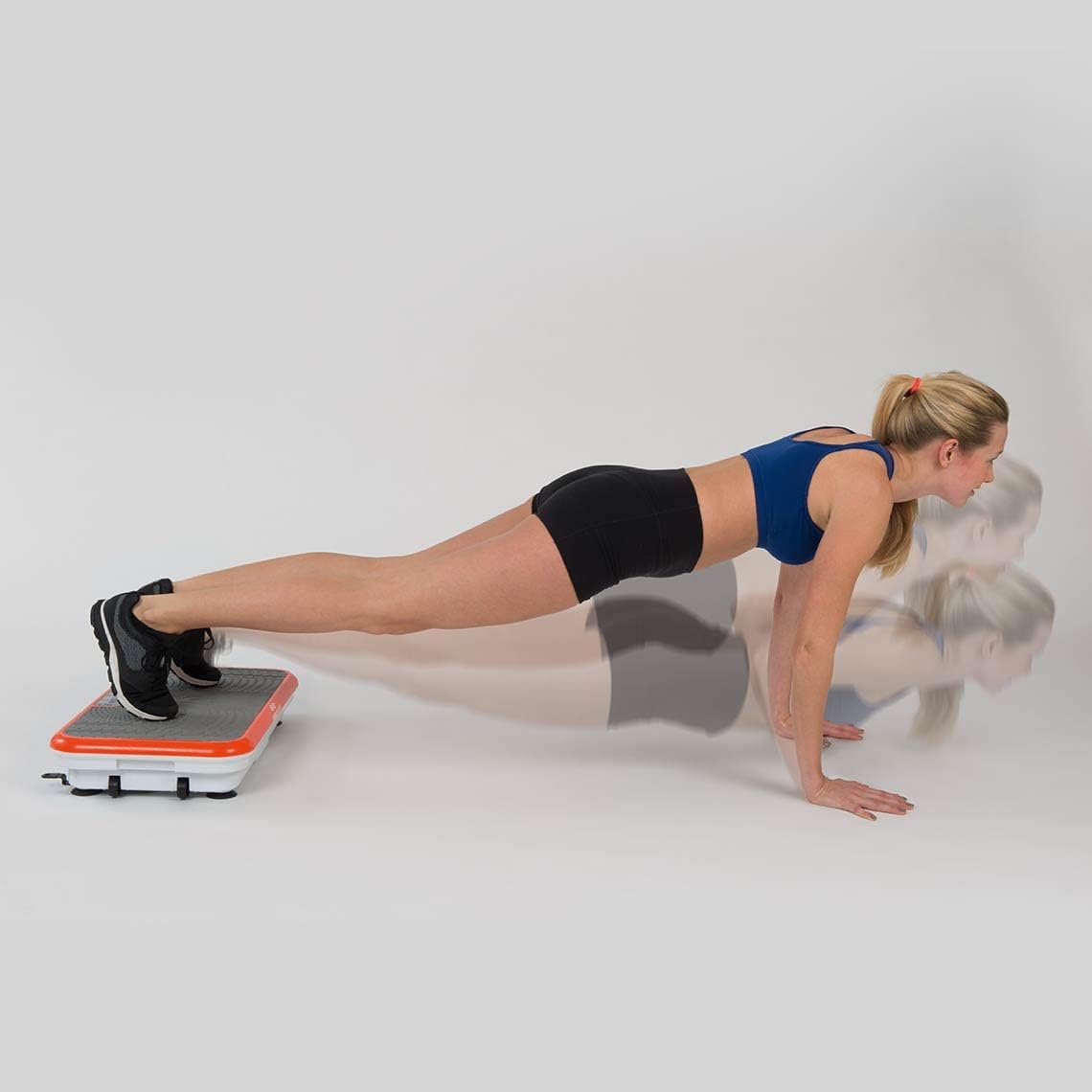 Woman in plank position with feet on Vibro Shaper platform