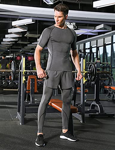 Un hombre en gimnasio vestido con conjunto de compresión gris, mostrando la camiseta y mallas mientras se entrena