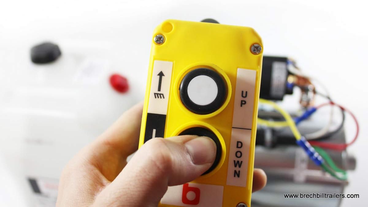 Hand holding the corded remote control for the hydraulic pump