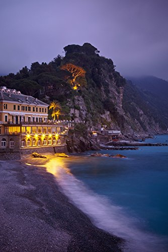 A Building Illuminated At Night Along The Coast