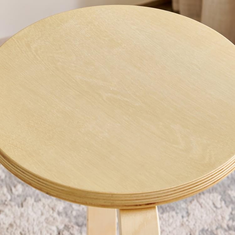 Close-up of the stool's seat surface showing wood grain and clear lacquer finish