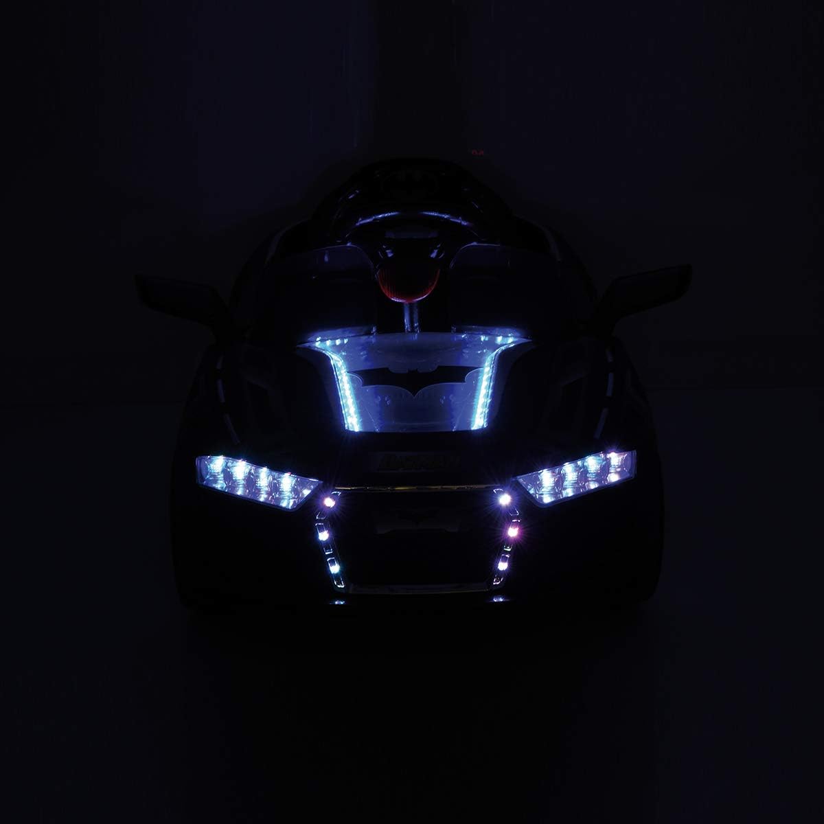Front view of Hauck E-Batmobile with LED lights illuminated in a dark setting