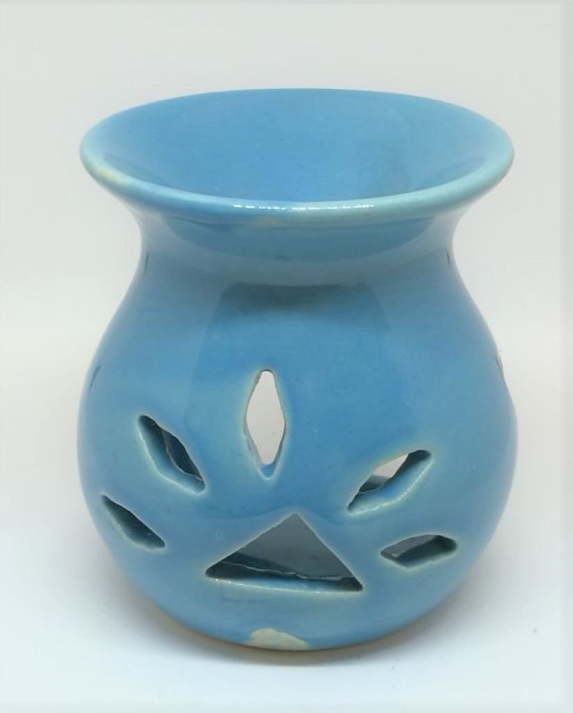 Small ceramic oil burner with a leaf cut out design. Blue