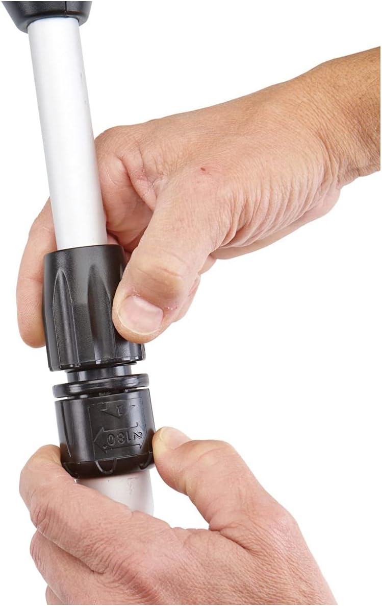 Hands connecting two sections of the trimmer shaft