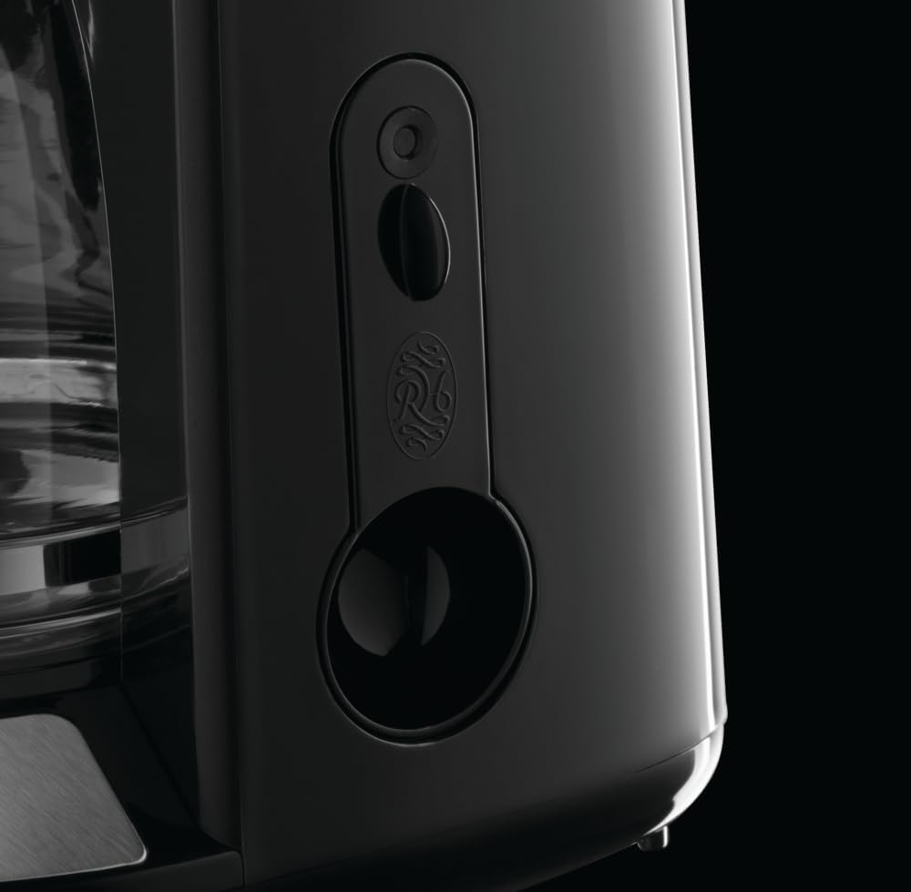 Latura view of coffee maker showing water level indicator and integrated spoon storage