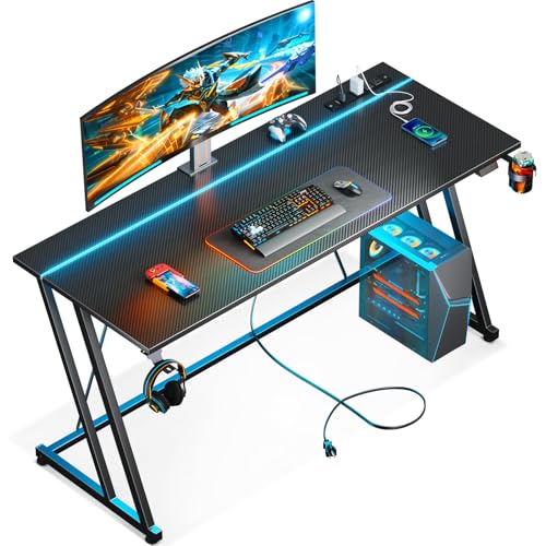 Image of MOTPK 55 Inch Gaming Desk with LED Lights & Power Outlet, Computer Desk for Small Space, Cheap Gaming Table with Carbon Fiber Texture, Kids Desk Gift for Boys Men, Black