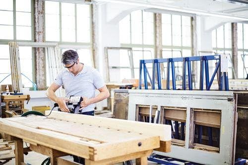 Person using Festool HL 850 EB-Plus Planer in a workshop