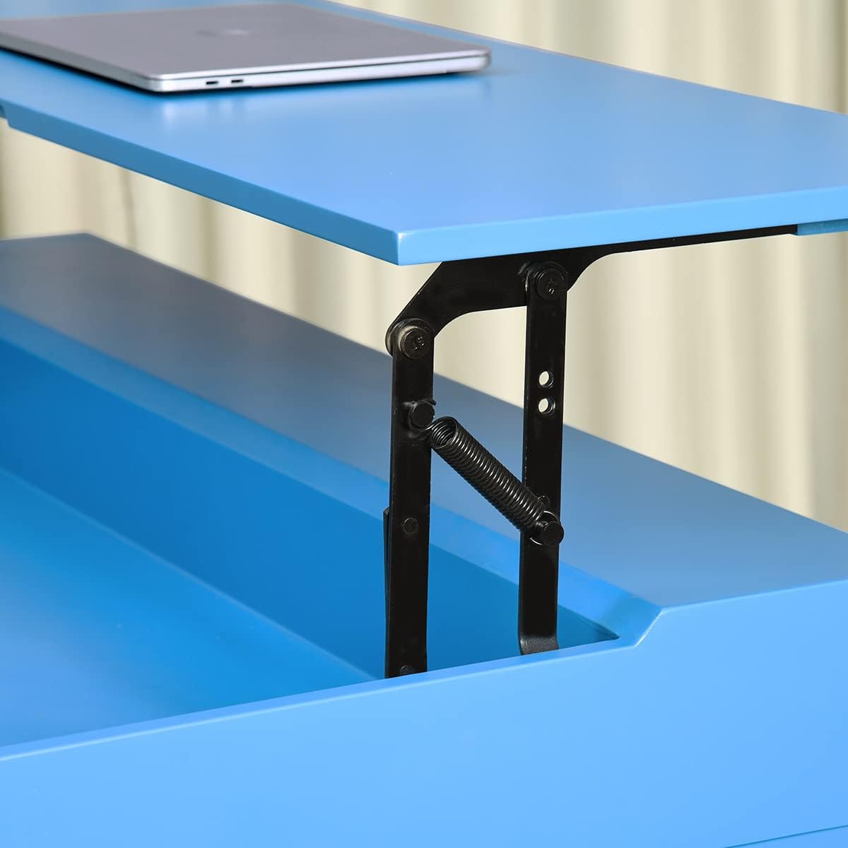 Close-up view of the lift mechanism components, including springs and hinges, supporting the raised desk top.