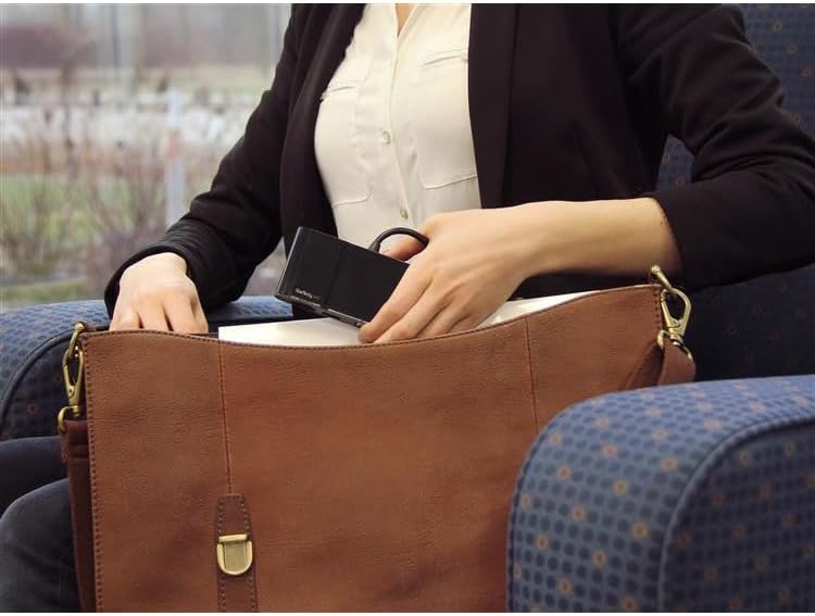 StarTech.com USB-C Multiport Adapter being placed into a bag