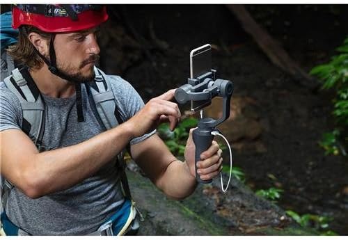 Man using DJI Osmo Mobile 2 to film outdoors