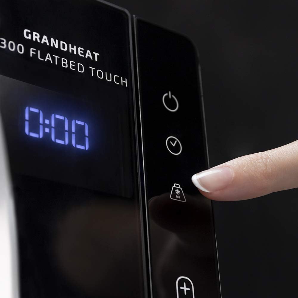 Finger pressing the defrost button on the microwave control panel