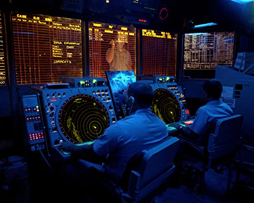 Crew members use radar screens to monitor air operations from the combat information center to the aircraft carrier USS KITTY HAWK (CV-63) - 12 Inch by 18 Inch Laminated Poster - Bright Colors And Vivid Imagery