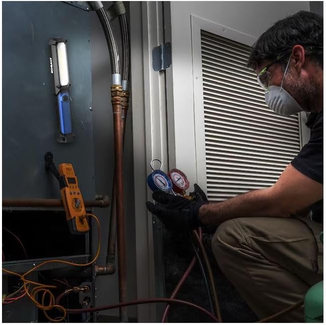 Kobalt work light magnetically attached to a metal panel while a technician works