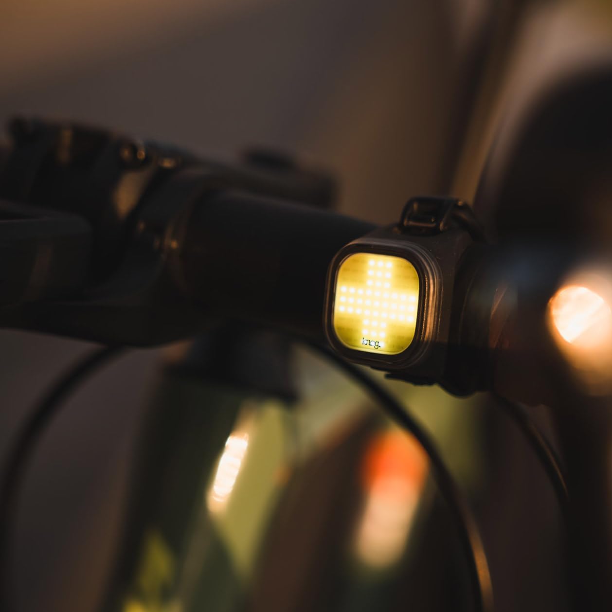 Knog Blinder Mini Bike Light mounted on a bicycle handlebar