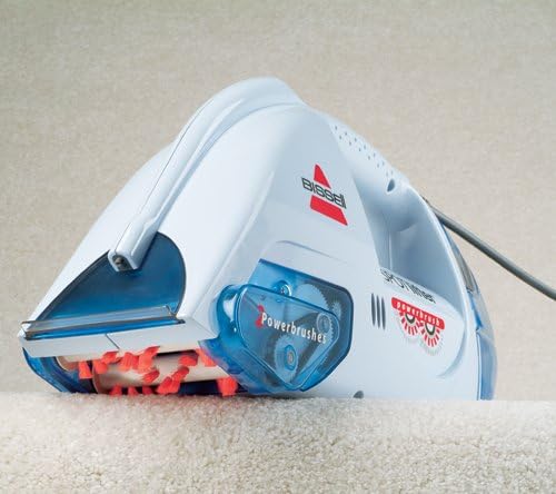 Bissell Spotlifter Powerbrush on a carpet, showing the rotating brushes in action.