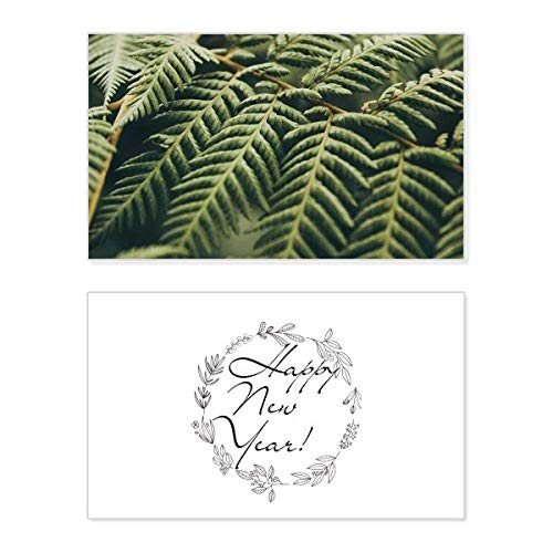 Tarjeta conmemorativa de año nuevo con diseño de fotografía botánica y mensaje de bendición