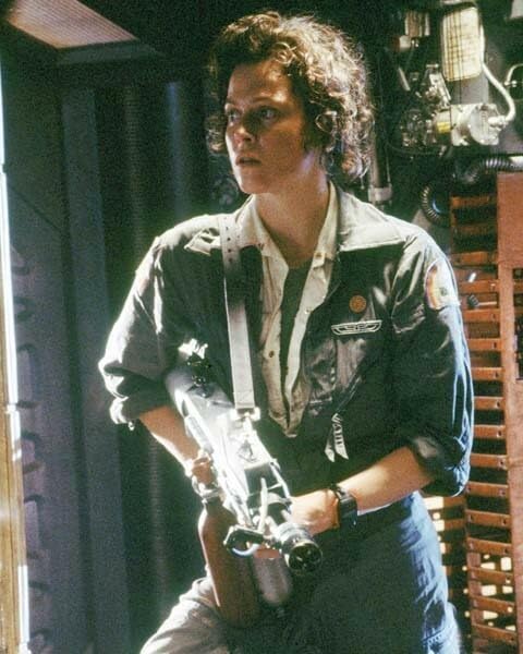 Sigourney Weaver ready for action armed with gun...