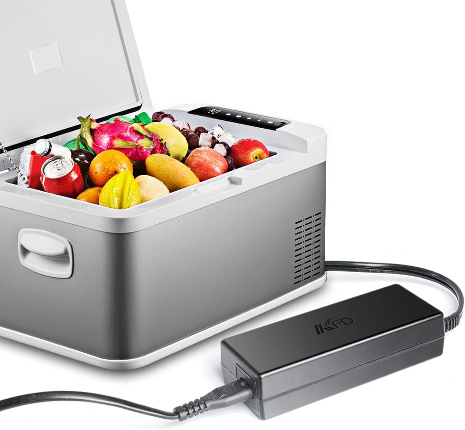 A portable car refrigerator filled with fruits and drinks, connected to the KFD AC adapter, demonstrating its use in powering the unit.