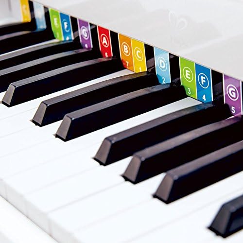 Close-up of Hape Deluxe White Grand Piano keys with colorful note labels
