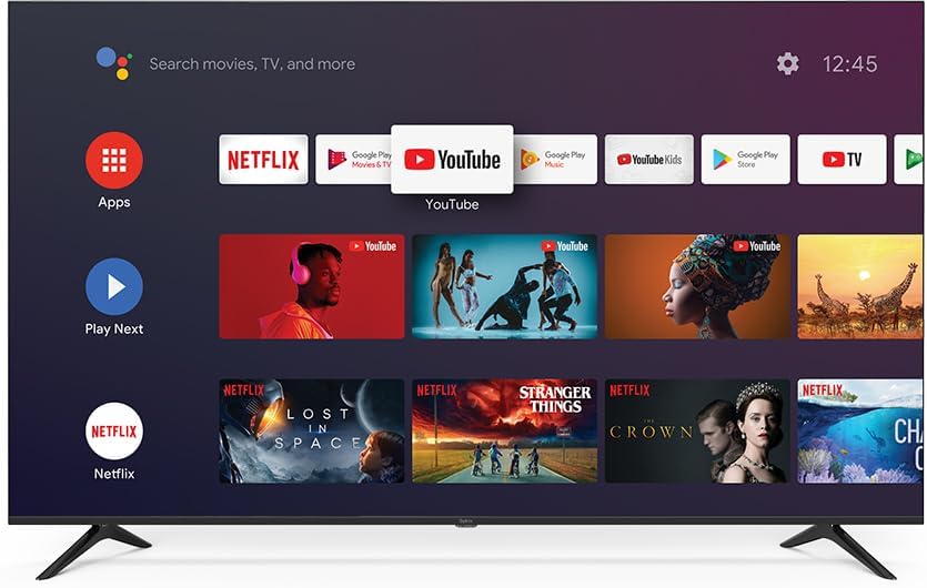 Sinix 65-inch QLED TV displaying the Android TV home screen with various app icons like Netflix and YouTube.