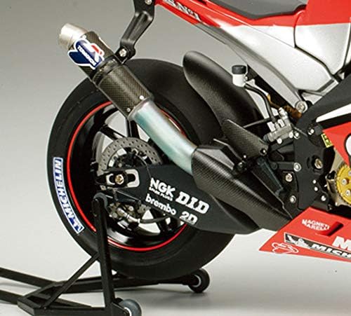 Close-up of the rear wheel and exhaust system of the Tamiya 1/12 Yamaha YZR-M1 2004 model, showing the intricate exhaust piping and rear suspension.