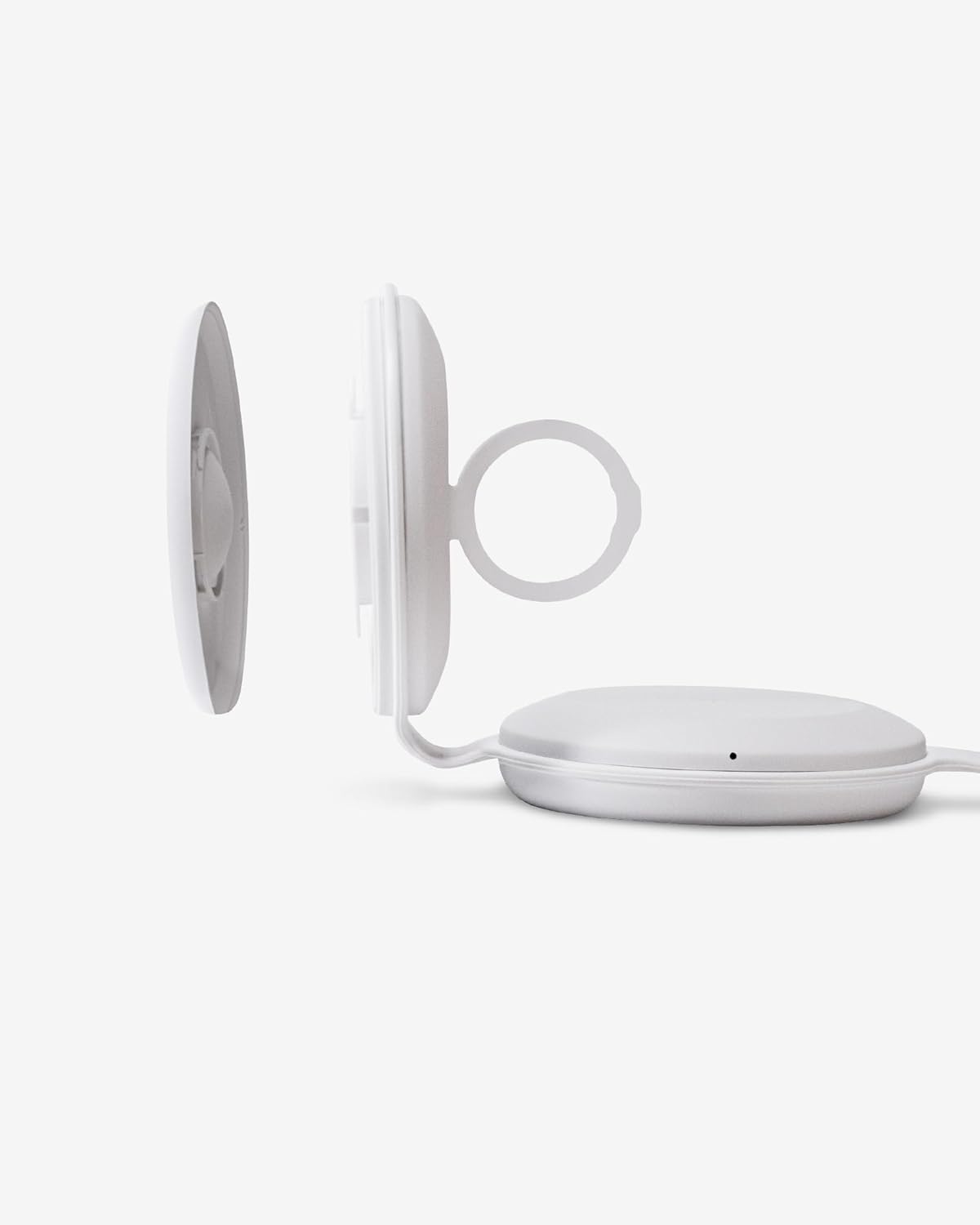 Close-up view of the Apple Watch charging module, detached to show the internal cable routing.