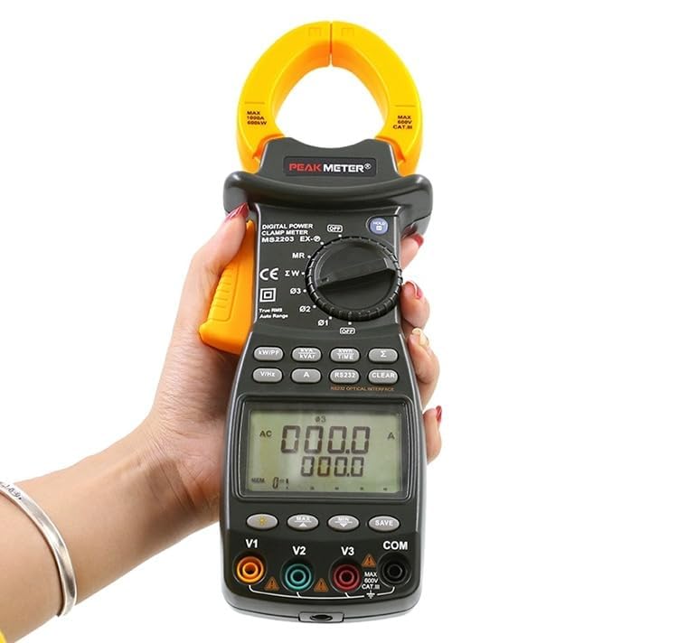 A hand holding the Mastech MS2203 clamp meter, showing its display and rotary switch with various function selections.