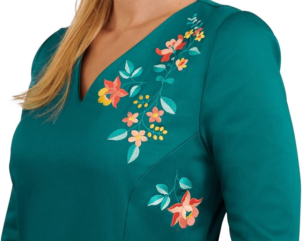 Example of an embroidered floral design on a green fabric