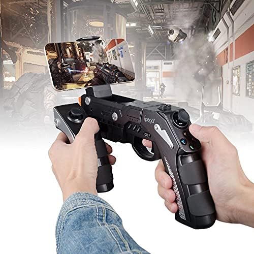 Person holding the ipega PG-9057 Wireless Game Controller with a smartphone mounted, playing a game.