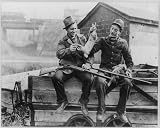 HistoricalFindings Photo: Men Seated on a Wagon Holding Rabbits,Shotguns,c1930's