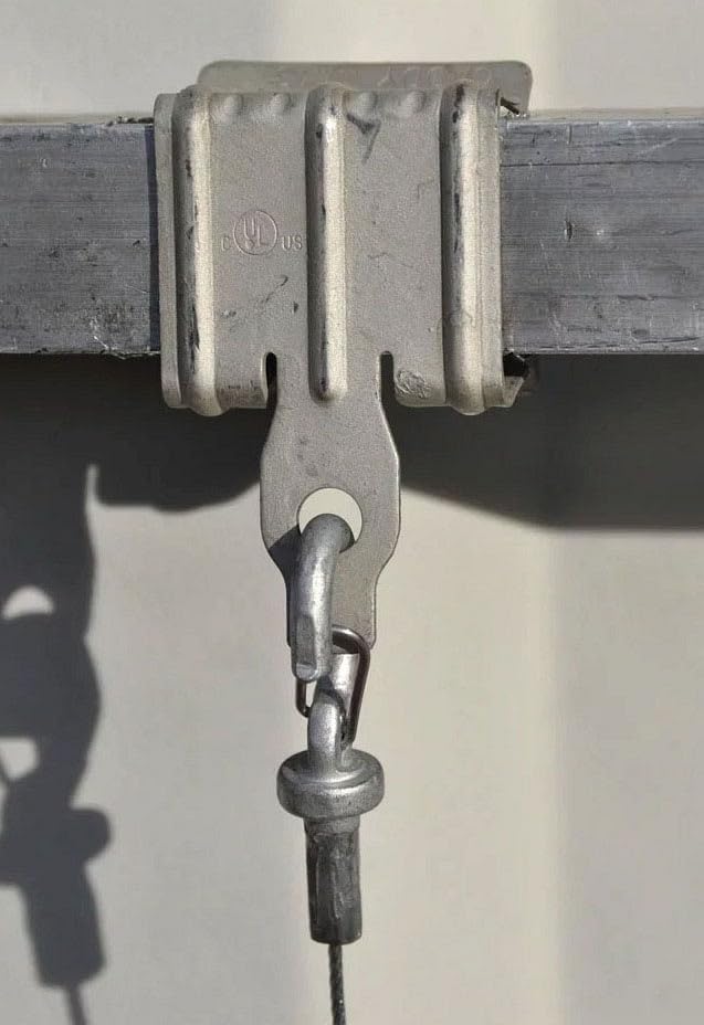 Erico 4H24 Flange Clip installed on a metal beam, holding a chain.