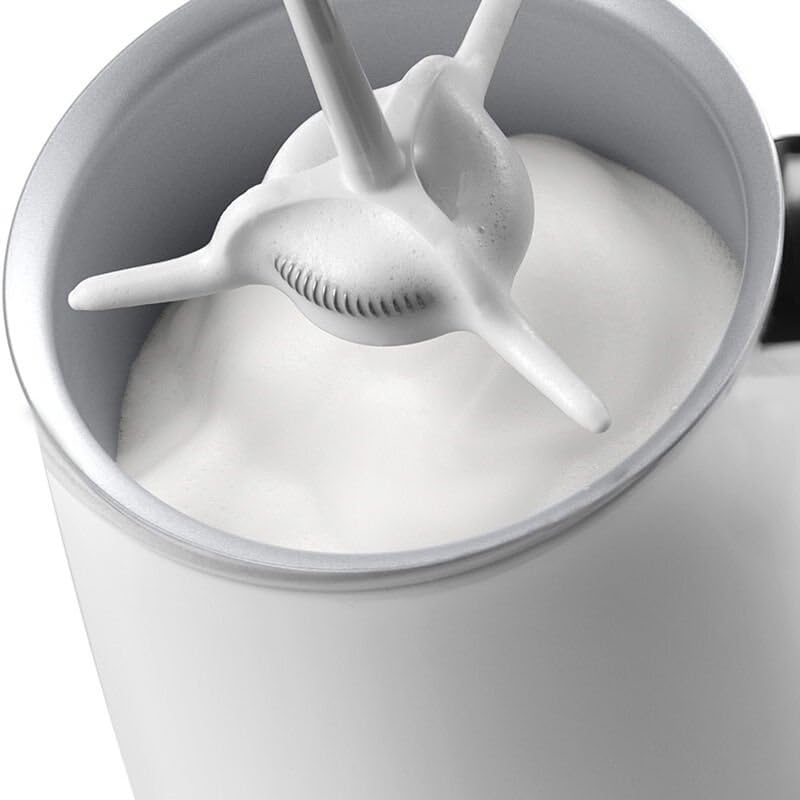 Close-up of milk being frothed inside the De'Longhi frother