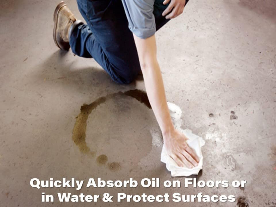 Person using Oil Eater pad to clean oil spill on concrete floor