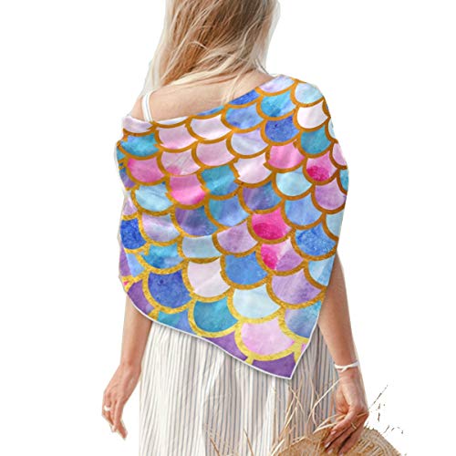 Square satin scarf in a pastel watercolor mermaid scale print, draped over a woman's shoulders