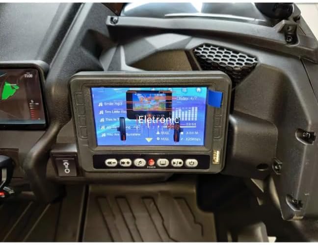 Close-up of the electric buggy's multimedia screen displaying music playback.