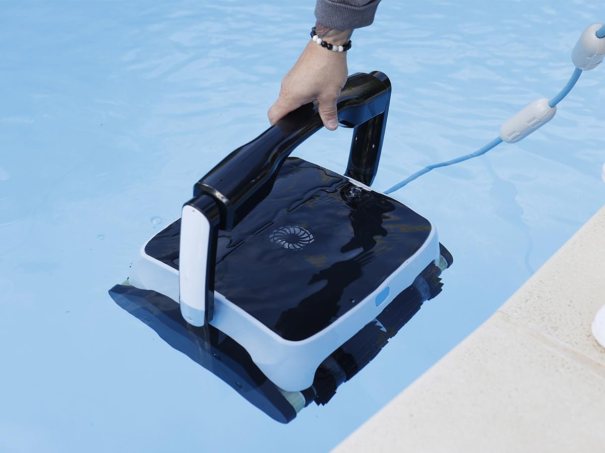 Hand holding the Ubbink Robotclean 3 Plus robotic pool cleaner handle in the water
