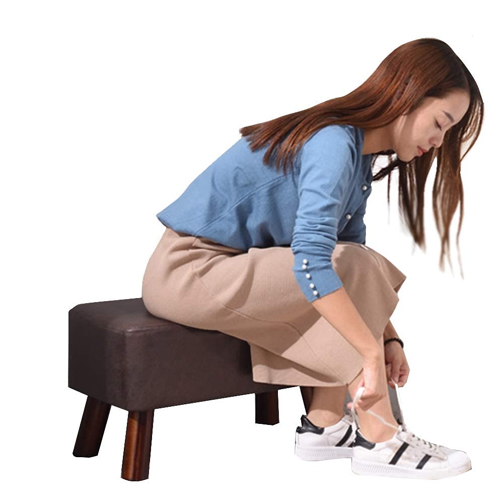 Pouf en tissu marron et repose-pied en bois massif pour salon chaleureux