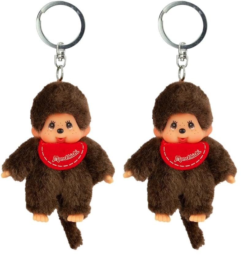 Sekiguchi 2534 - Original Monchhichi Mädchen oder Junge als Schlüsselanhänger Plüschfigur mit Lätzchen ca 10 cm großer Anhänger aus braunem Plüsch für Rucksäcke Taschen und Federmappen