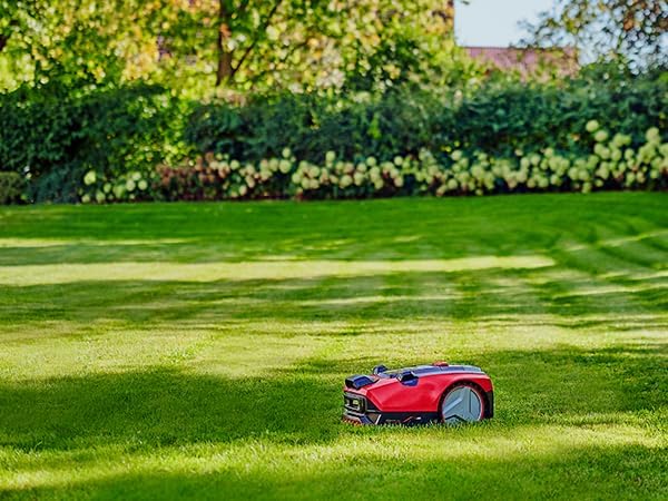 The Einhell robotic lawnmower operating autonomously on a green lawn.
