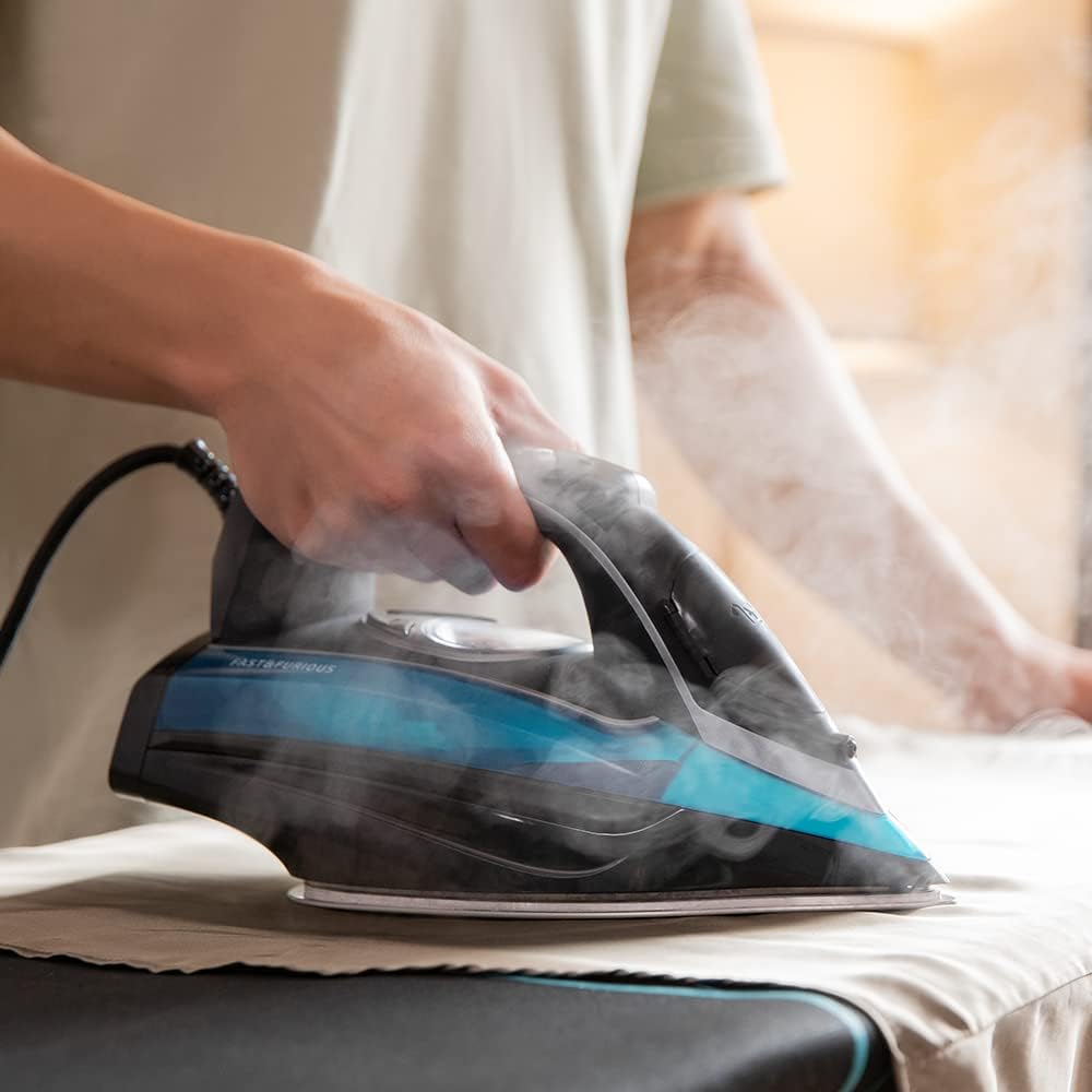 Steam iron in use, emitting steam