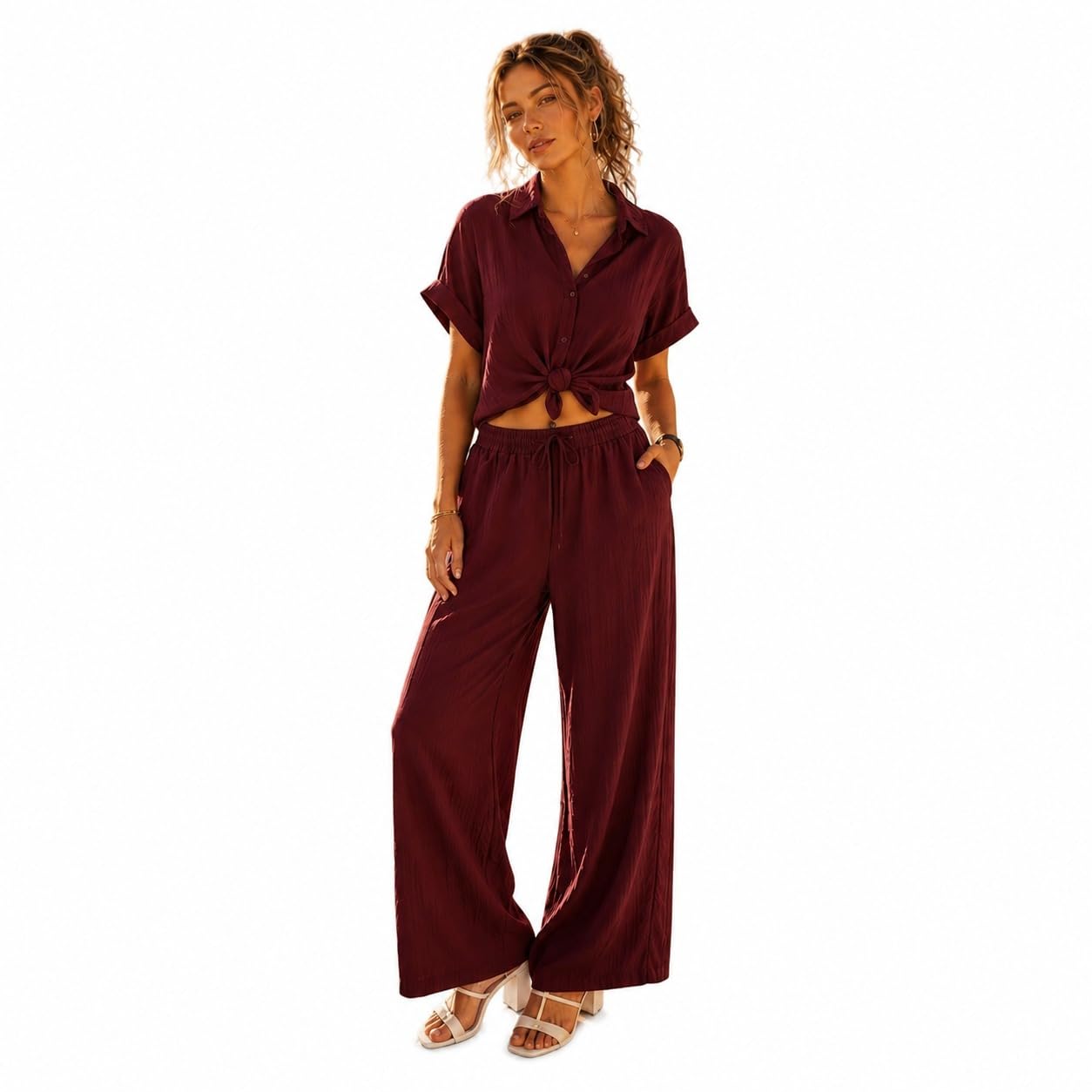 FEZI A short-sleeved, button-down collared shirt wide-leg, loose-fitting trousers that appear to be made of a textured, lightweight fabric.
