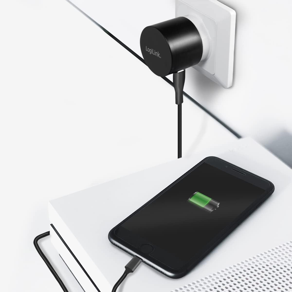 LogiLink PA0274 USB Wall Charger plugged into a wall outlet and charging a smartphone