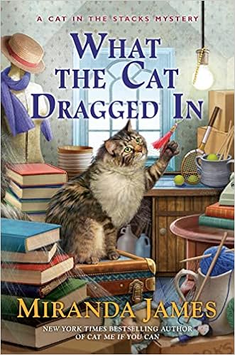 What the Cat Dragged In (Cat in the Stacks Mystery) book cover