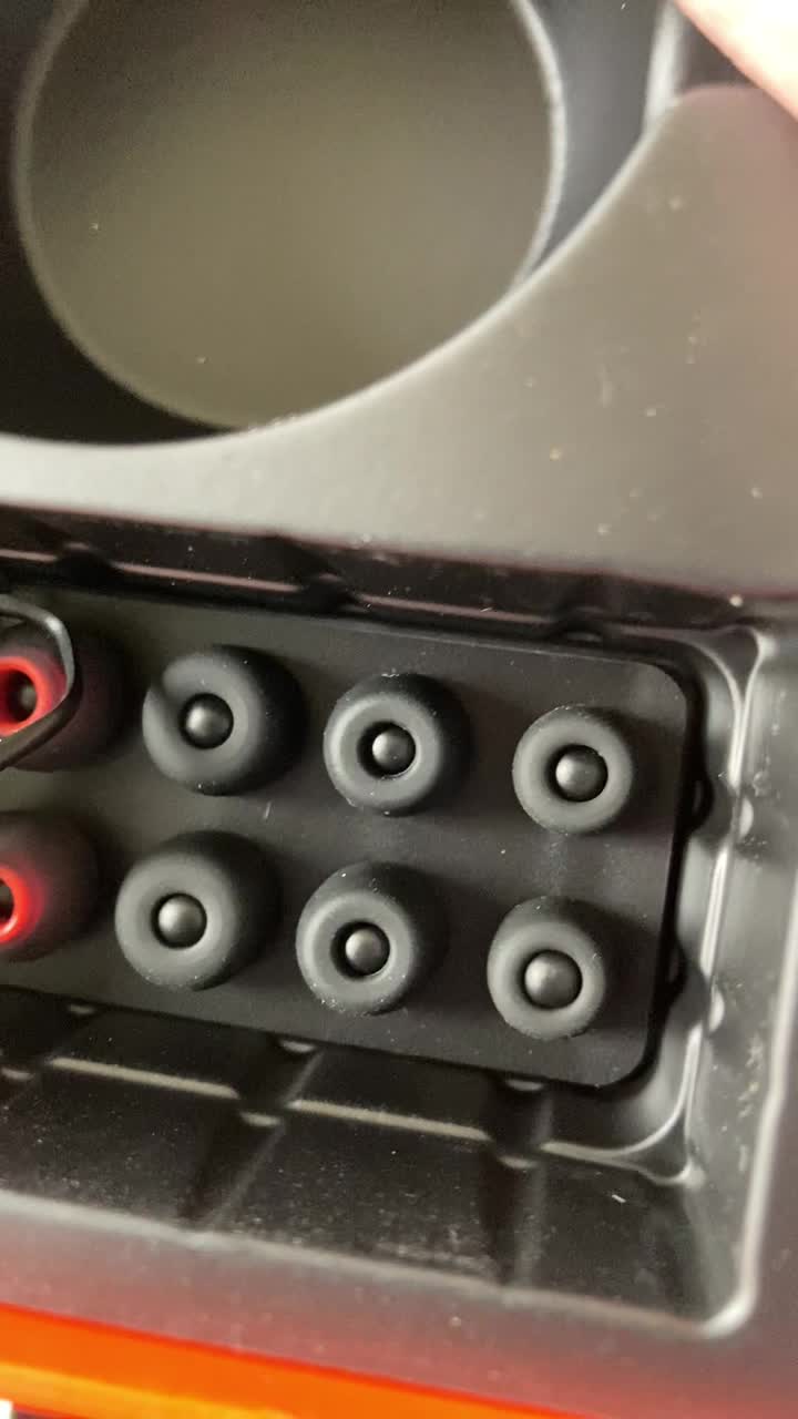 Tribit FlyBuds C1 charging case with earbuds inside, showing LED battery indicators