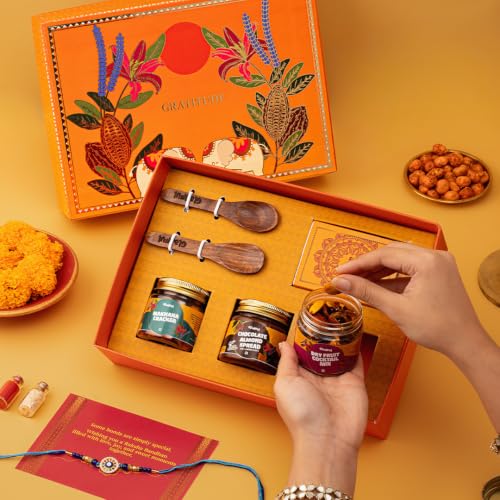 Image of Gladful Premium 7 Items Rakhi Gift Box for Brother | Orange Elephant Hamper with Gourmet Snacks, Chocolate Spread, Rakhi & Greeting Card | Luxurious Raksha Bandhan Gift