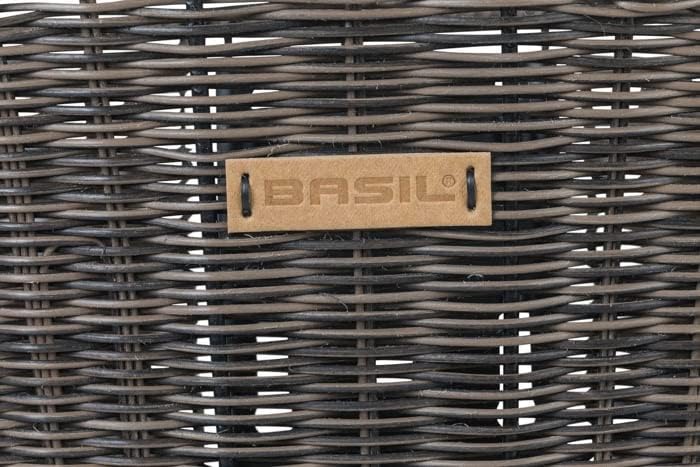 Close-up of the Basil logo on the rattan bicycle basket