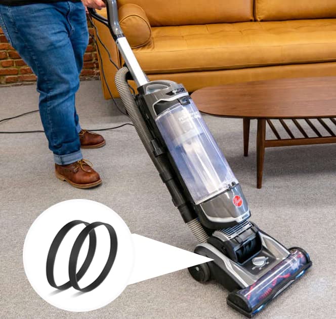 A Hoover vacuum cleaner in use on a carpet, with an inset showing two replacement belts.