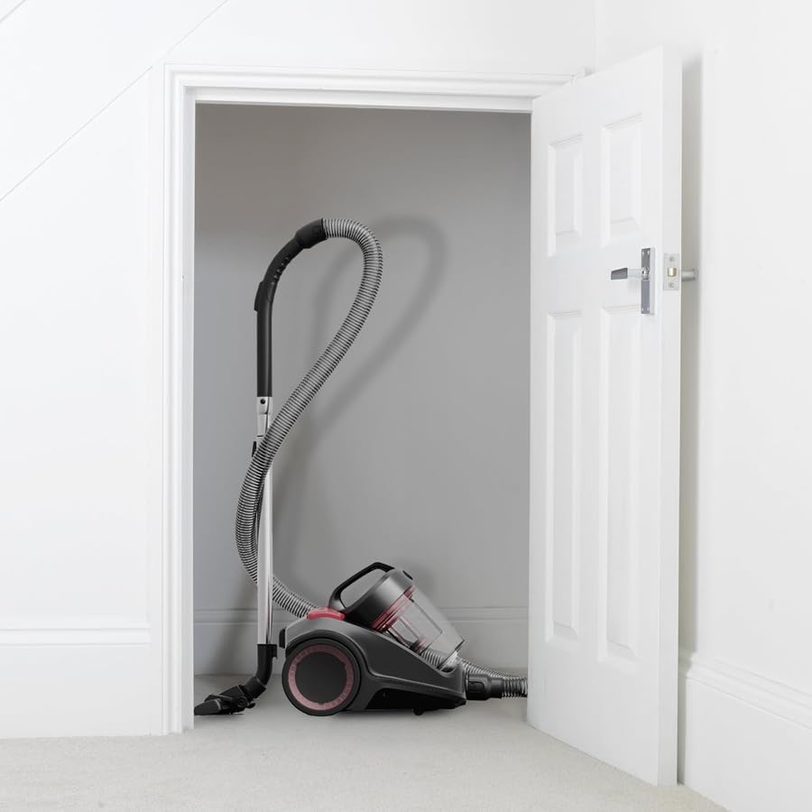 Woman carrying Hoover Power 6 Advanced vacuum cleaner up stairs