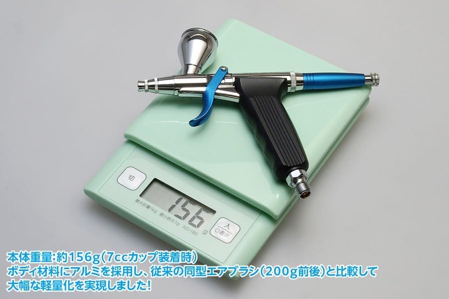 Airbrush on a digital scale showing 156g